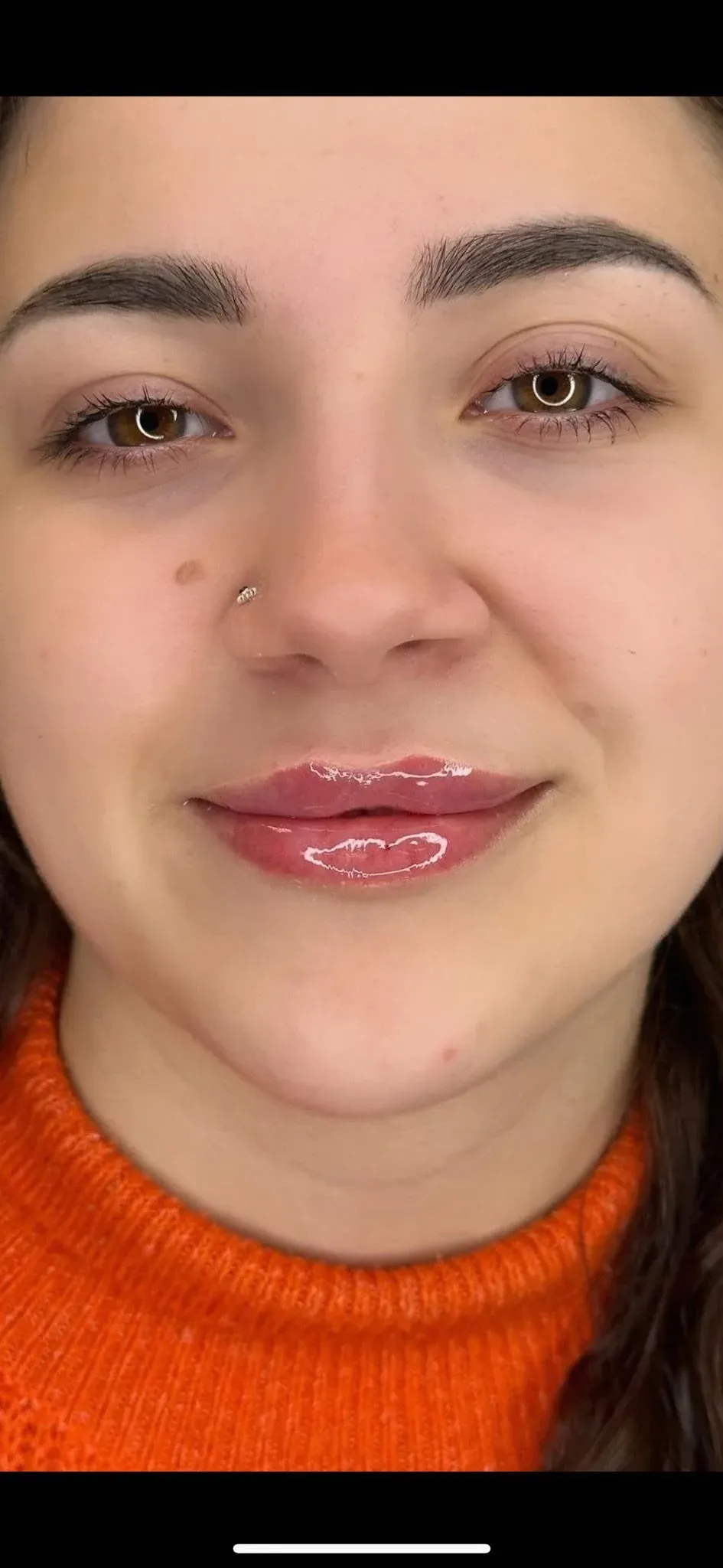 A smiling client at Essence Beauty